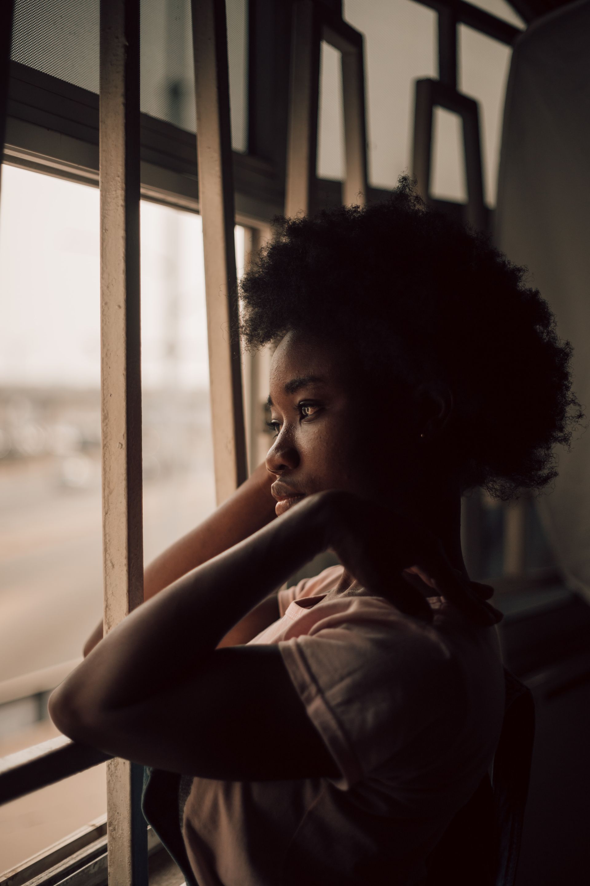 Woman looking out window thinking